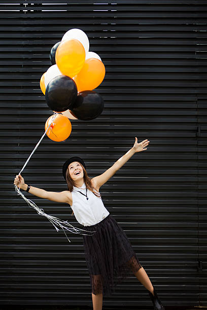 istock Girl dressed for Halloween with balloon 600412286