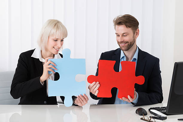 istock Businesspeople Holding Puzzle Pieces 600412918