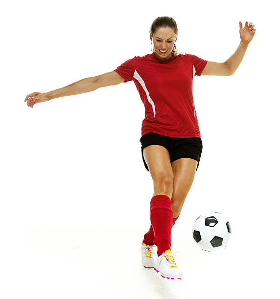 weibliche fußball spieler treten den ball  - arms outstretched arms raised studio shot adult stock-fotos und bilder