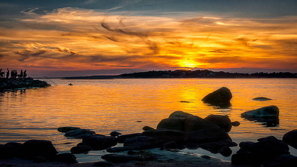 istock Beautiful sunset cloudscape at waterfront and people bathing. 600414538