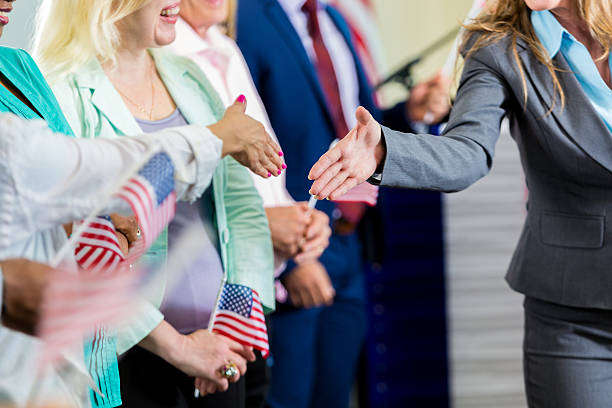 istock Female politician shaking hands with supporters at event 600414806
