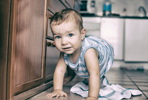 istock Happy baby boy crawling in the kitchen 600416140