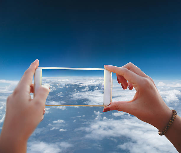 istock Woman photographing clouds 600416206