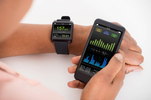 istock Hand With Mobile And Smartwatch Showing Heartbeat Rate 600416482