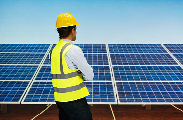 istock Rear view of solar worker standing outdoors 600417798