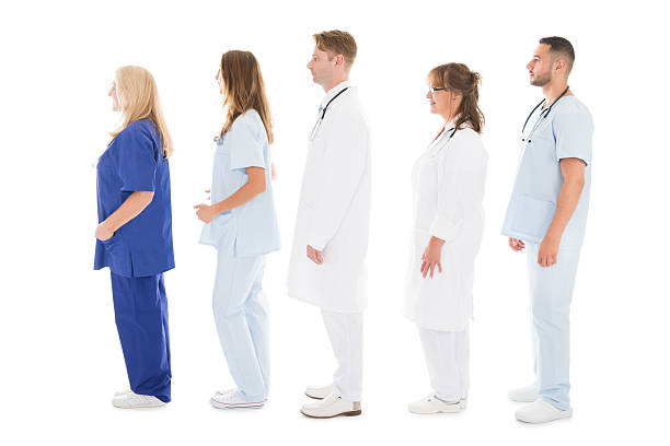 istock Side View Of Medical Professionals Standing In Row 600418556