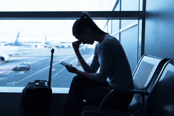 Delayed flight Stressed woman in the airport. cancellation photos stock pictures, royalty-free photos & images