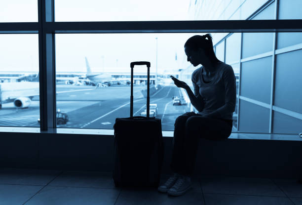 istock Female traveler using her cellphone 600418606