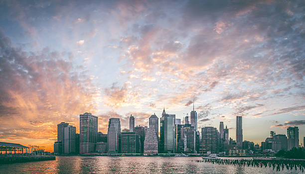 Skyline New York City Manhattan and Brooklyn Bridge At Sunset stock photo
