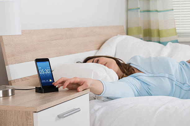 istock Woman Snoozing Alarm On Mobile Phone 600668018