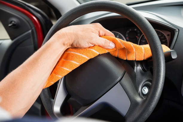 istock Worker Polishing Car Steering Wheel 600668896
