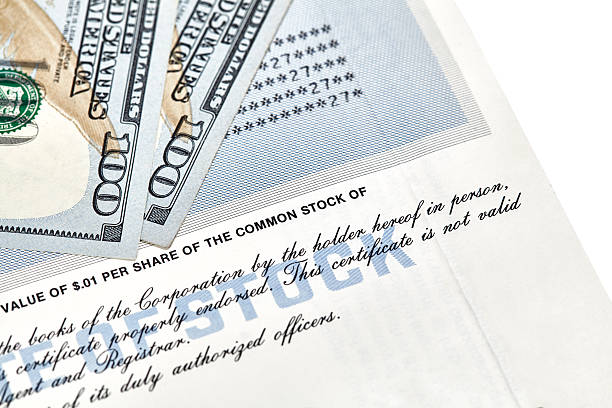 istock Stock Certificate Shares with US One Hundred Dollar Bills 600673918