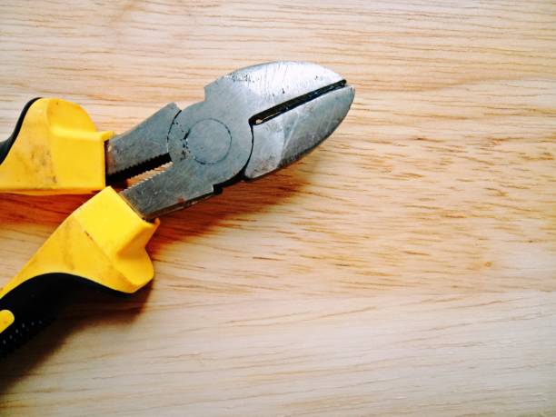 istock Nippers worker equipment on wooden background 600674326