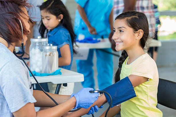 istock Young Hispanic patient getting blood pressure checked by nurse 600674398