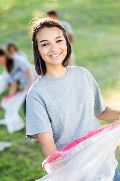 istock Cheerful teen helping with park clean up 600674416
