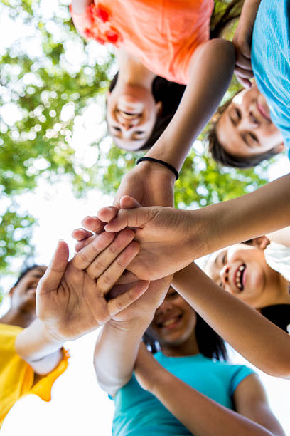 istock Diverse group of kids outdoors in a huddle 600674442