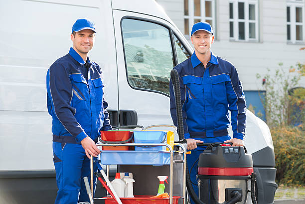istock Happy Janitors Standing Against Truck 600675002