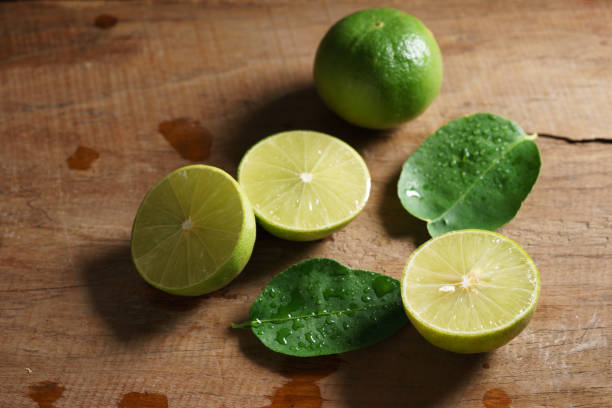 istock fresh limes on wooden background 600676518