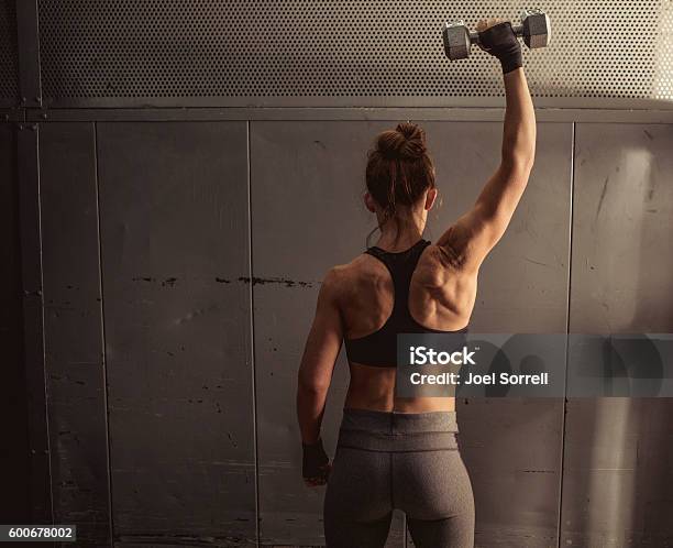 Woman Lifting Weights Stock Photo - Download Image Now - Shoulder, Exercising, Dumbbell