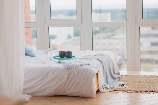 istock Two mugs on a tray white bed, breakfast concept 600678234