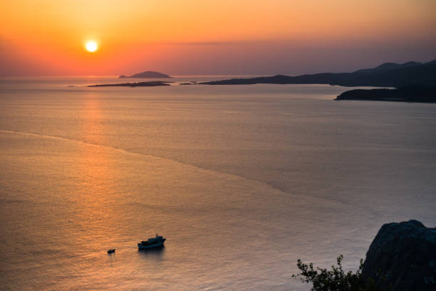 istock Sunset at sea, with small greek islands in background 600678238