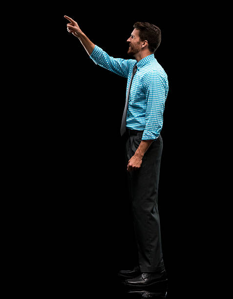 istock Smiling businessman pointing away 600679926