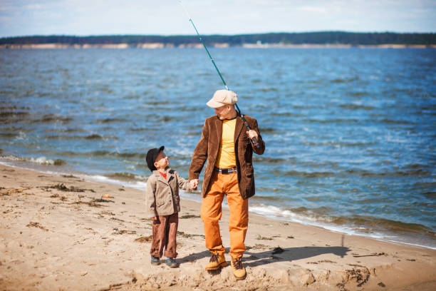 The Family fishing. Dad with the son fishing on the river. fishing rod photos stock pictures, royalty-free photos & images