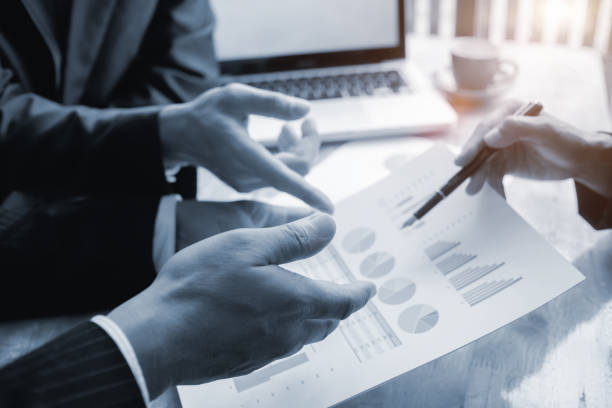 istock business people discussing annual report on desk work 600680794
