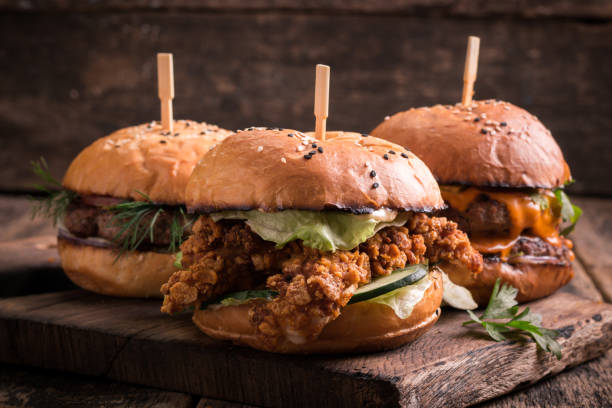 istock Tasty grilled burger with lettuce and mayonnaise , rustic wooden table 600683974