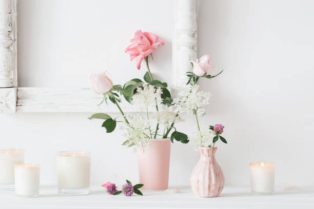 istock flowers in a vase and candles on white background 600684732