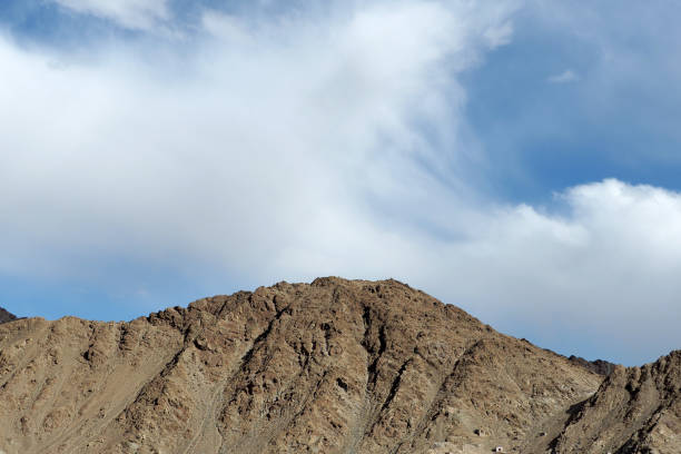 Top of rock mountain in blue cloud sky - with copyspace in Leh, Ladakh, India.