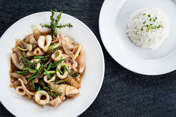 fresh squid and kampot green pepper stir fry meal fresh squid and kampot green pepper stir fry traditional asian cambodian seafood meal kampot stock pictures, royalty-free photos & images