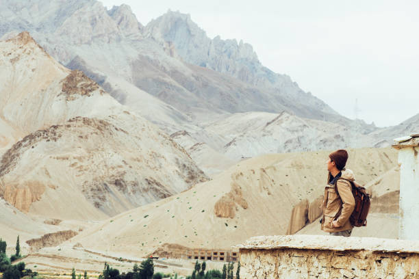 istock Young male traveler standing on the sand cliff 600687112