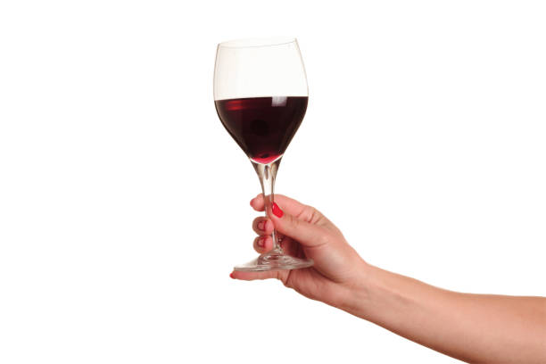 istock female hand with red wine glass 600688418