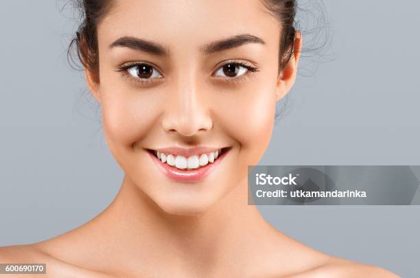 Beautiful Face Of Young Woman With Perfect Skin Gray Background Stock Photo - Download Image Now