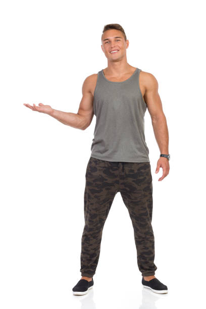 istock Fit Man In Camo Pants Presenting 600690264