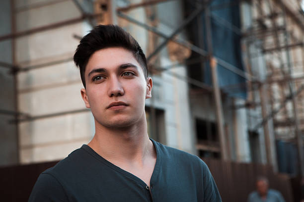 istock Young attractive man in urban background 600696318