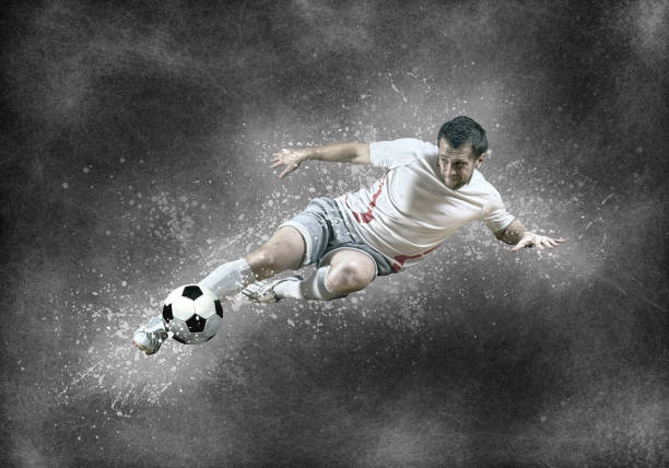 istock Football player with ball in action under sky with clouds 600696902