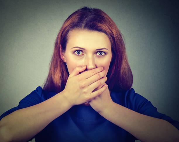 istock Concerned scared woman covering her mouth with hands 600698032