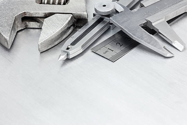 istock tool set of calipers, wrenches and ruler on scratched metal 600700346