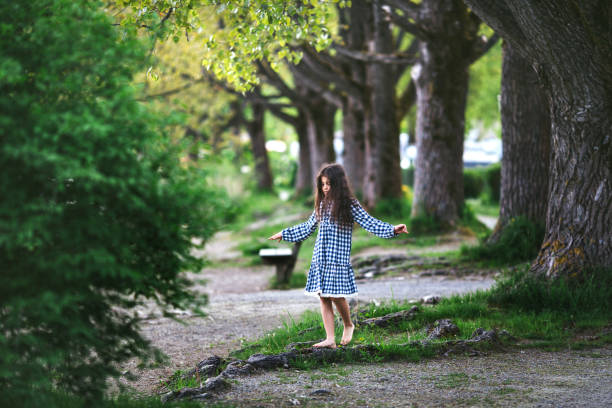 istock Little girl near the big tree 600701096