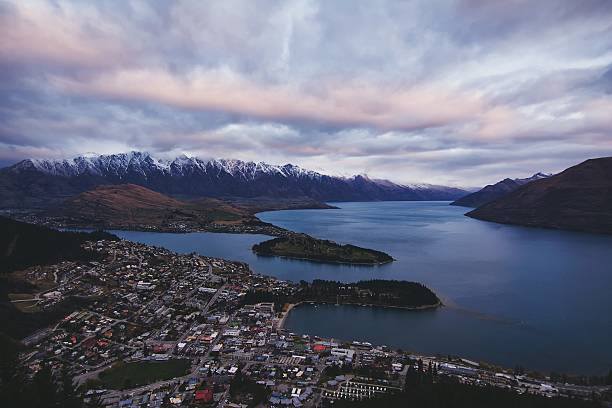 istock Houses By River And Mountains Against Cloudy Sky 600762393