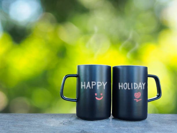 istock Two coffee or tea cup  in morning wording happy holiday 600990272