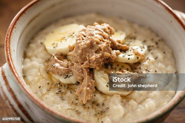 Porridge Topped With Slice Banana Chia Seeds Honey Peanut Butter Stock Photo - Download Image Now