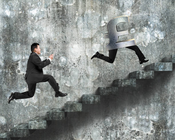 istock Man running after pound money symbol 600991782