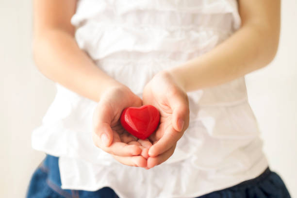 istock Little girl holding a red heart. 600992154