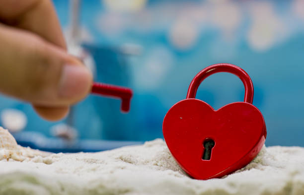 red heart key on the beach