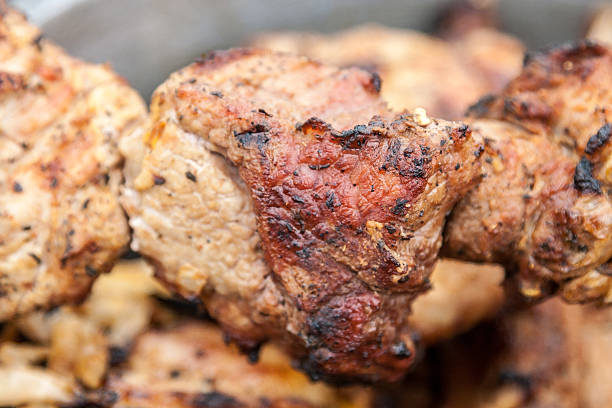 Roasted over an open fire pork meat close-up.