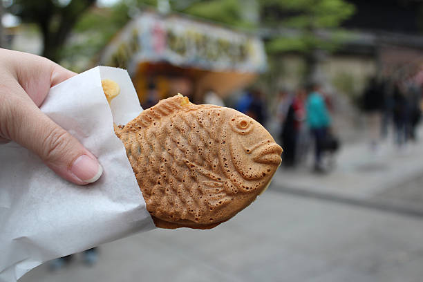 Taiyaki, japanese fish shape pancake Taiyaki is fish-shaped pancake stuffed with sweetened red bean paste as a common street snack in Japan red bean dessert stock pictures, royalty-free photos & images