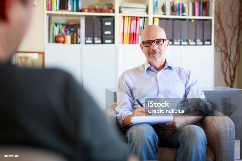 Therapy session, adult man talking to his psychotherapist Men Stock Photo